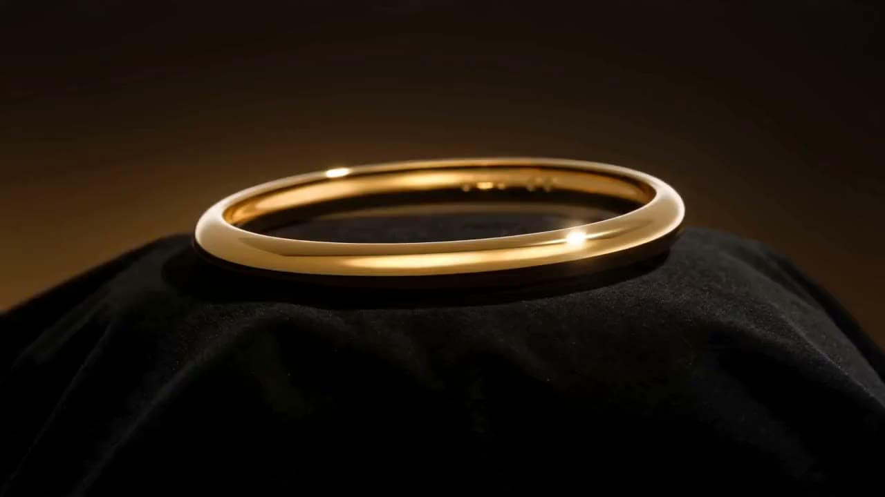 A jewelry store display: light gliding over gold bracelets, macro shot. Still from a video made with Seedance 2.0.